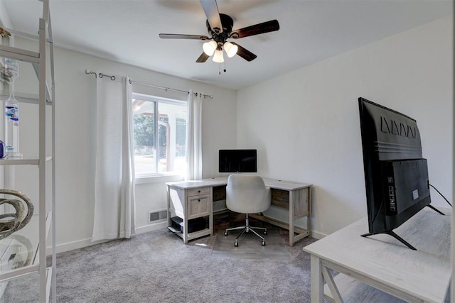 home office with ceiling fan and light carpet