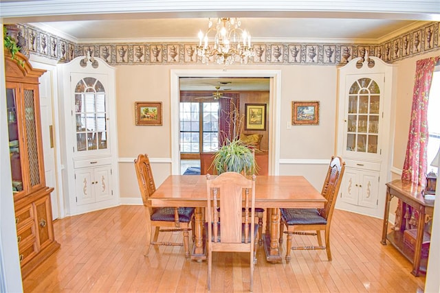 dining space with ceiling fan with notable chandelier, light hardwood / wood-style floors, and crown molding