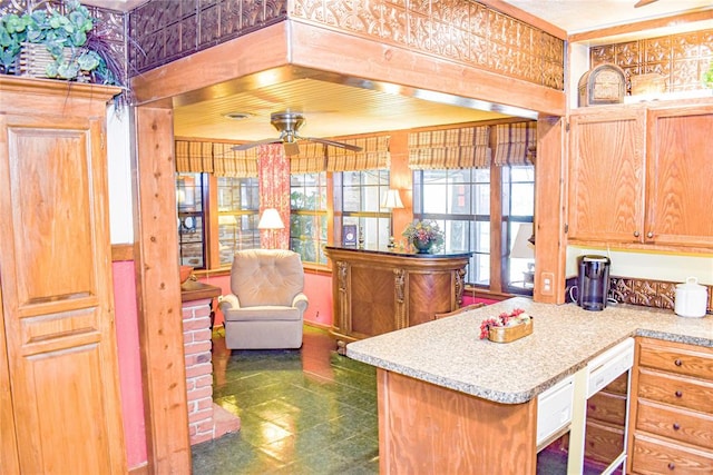 kitchen with dishwashing machine, kitchen peninsula, and ceiling fan