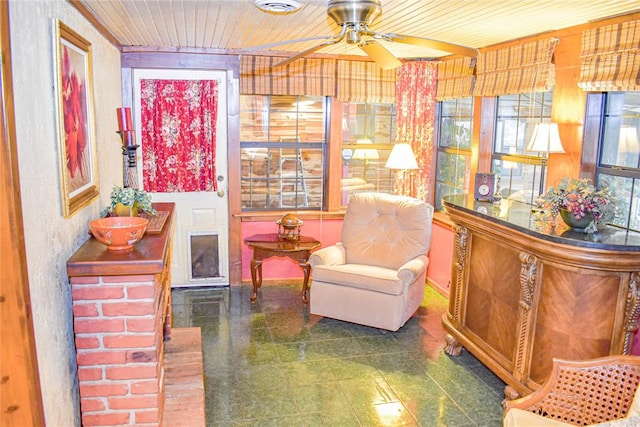 sitting room with ceiling fan and wooden ceiling