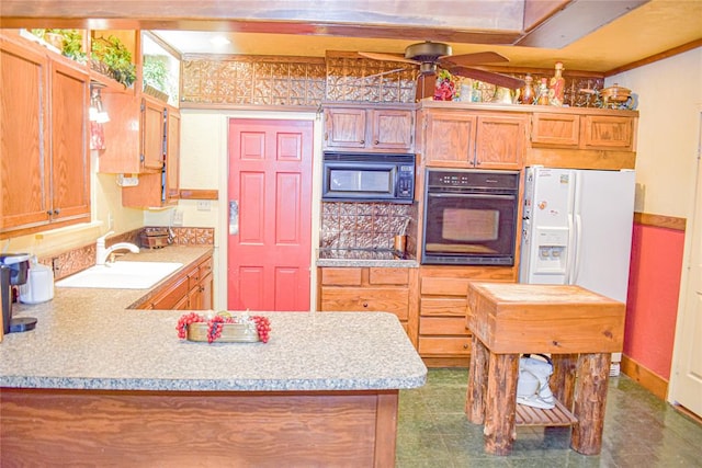 kitchen featuring kitchen peninsula, ceiling fan, sink, black appliances, and decorative light fixtures