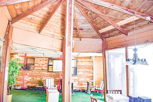 interior space with vaulted ceiling with beams, log walls, wooden ceiling, and an inviting chandelier