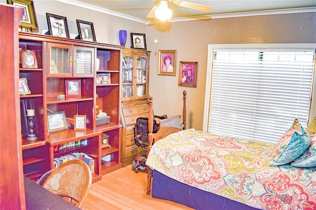 bedroom featuring hardwood / wood-style floors, ceiling fan, and ornamental molding