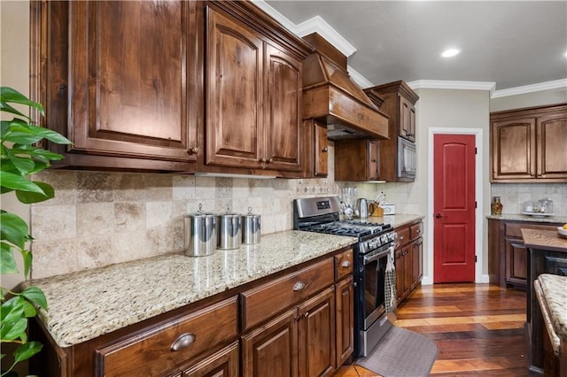 kitchen with light stone countertops, dark wood-type flooring, decorative backsplash, appliances with stainless steel finishes, and ornamental molding