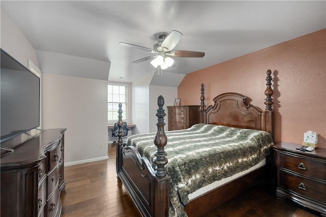 bedroom with dark hardwood / wood-style flooring, ceiling fan, and lofted ceiling