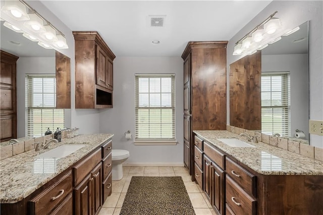 bathroom with tile patterned floors, vanity, and toilet