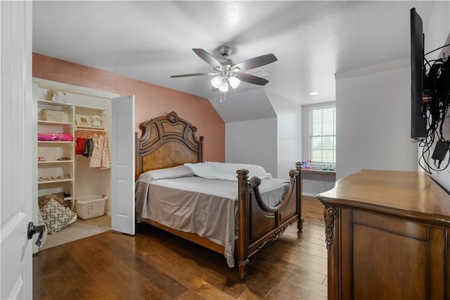 bedroom with dark hardwood / wood-style floors, ceiling fan, lofted ceiling, and a closet