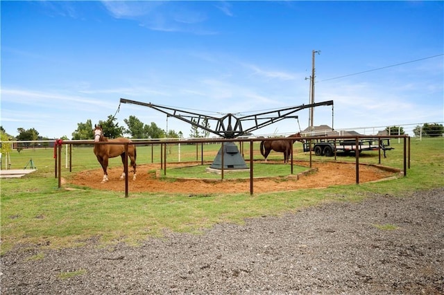 view of jungle gym with a rural view and an outdoor structure