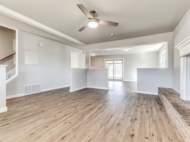 unfurnished living room with ceiling fan and light hardwood / wood-style floors