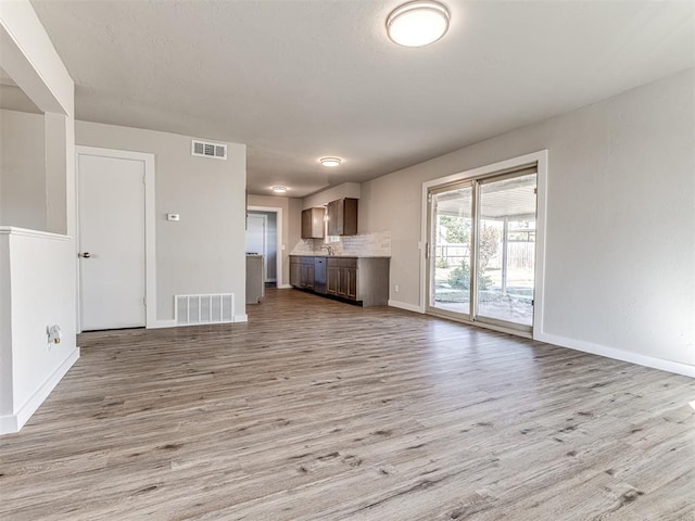 unfurnished living room featuring light wood-type flooring