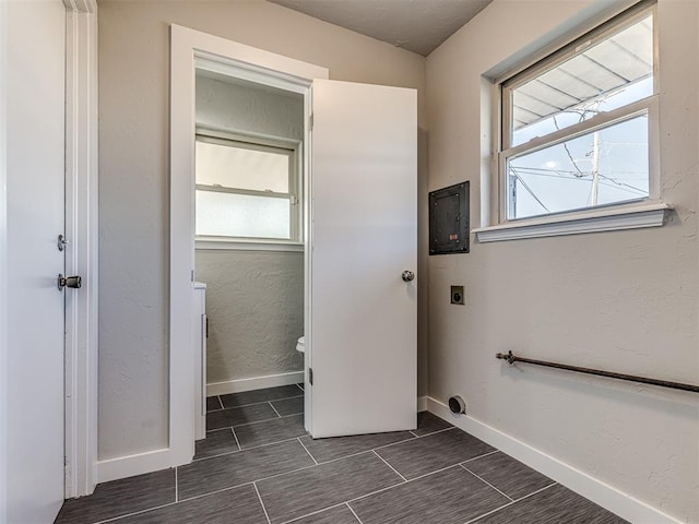 laundry area featuring electric dryer hookup and plenty of natural light