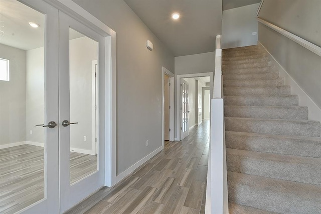 stairs with french doors