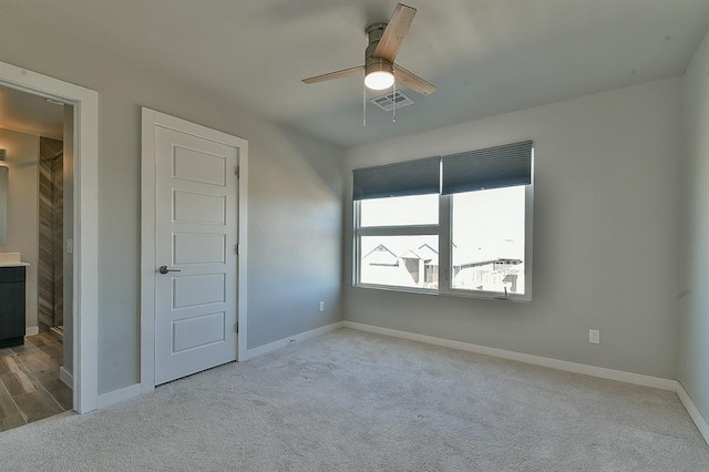 unfurnished bedroom with light colored carpet and ceiling fan