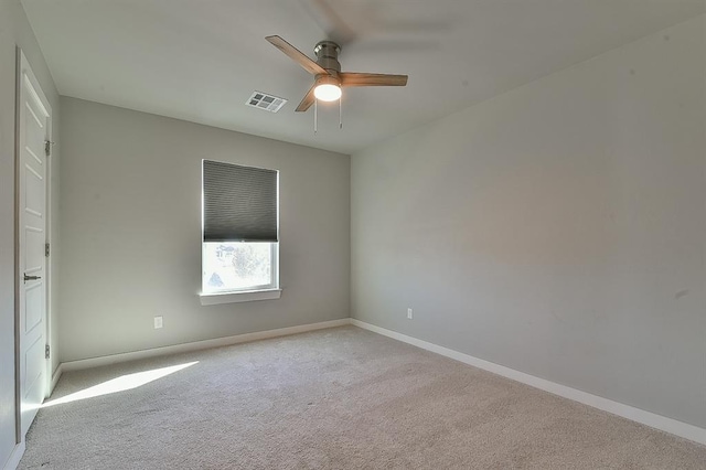 unfurnished room featuring light carpet and ceiling fan