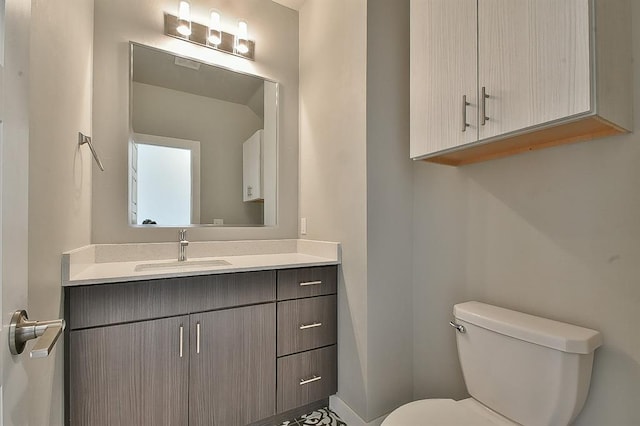 bathroom featuring vanity and toilet