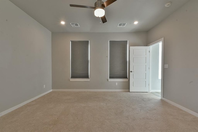 carpeted spare room featuring ceiling fan