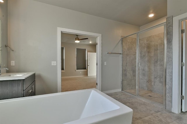 bathroom featuring vanity, ceiling fan, and plus walk in shower