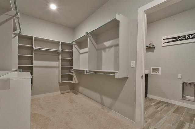 spacious closet with light hardwood / wood-style flooring