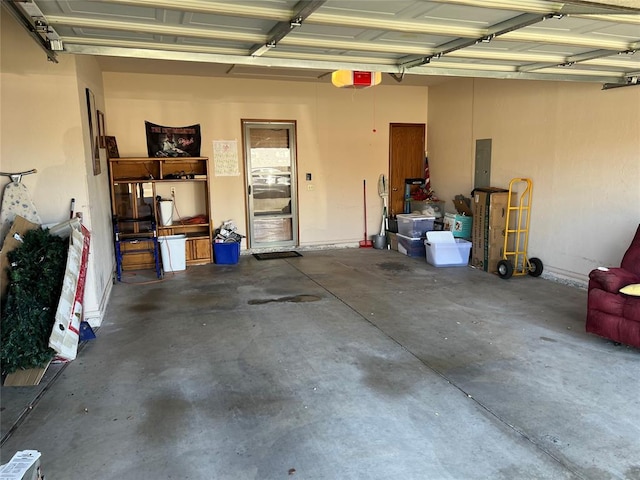 garage featuring electric panel and a garage door opener