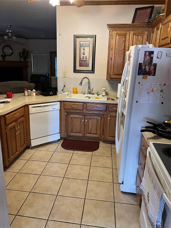 kitchen with white appliances, sink, and light tile patterned floors