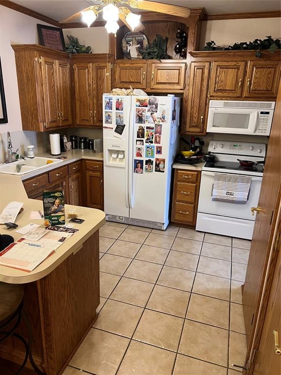 kitchen featuring ceiling fan, white appliances, ornamental molding, and light tile patterned floors