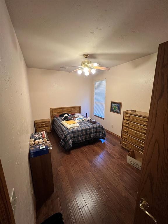 bedroom featuring dark hardwood / wood-style floors and ceiling fan