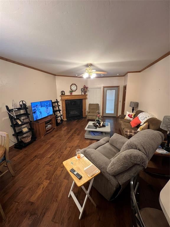 living room featuring dark hardwood / wood-style flooring, ceiling fan, and crown molding