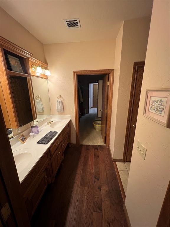 bathroom with hardwood / wood-style floors and vanity