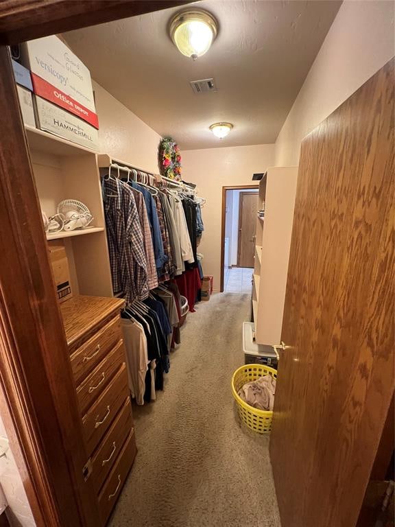 walk in closet featuring carpet floors