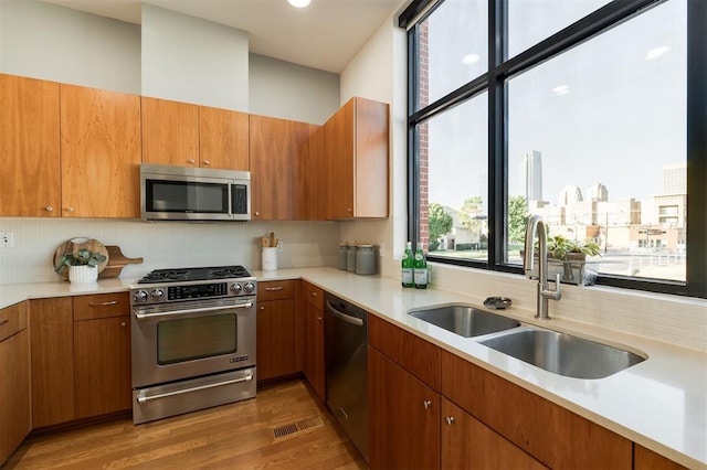 kitchen featuring decorative backsplash, sink, dark wood-type flooring, and appliances with stainless steel finishes