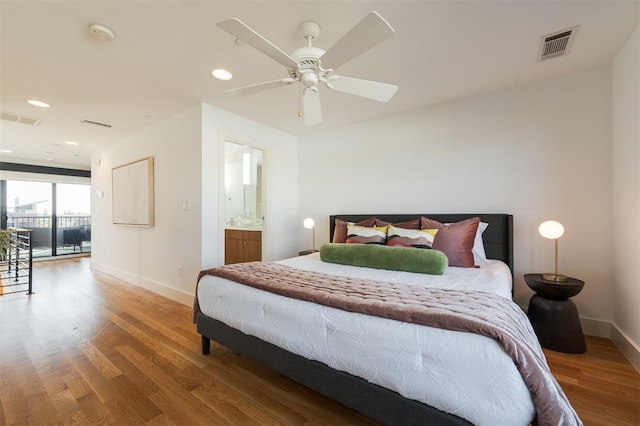 bedroom with hardwood / wood-style floors, access to outside, ensuite bath, and ceiling fan