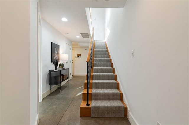 stairway featuring concrete flooring