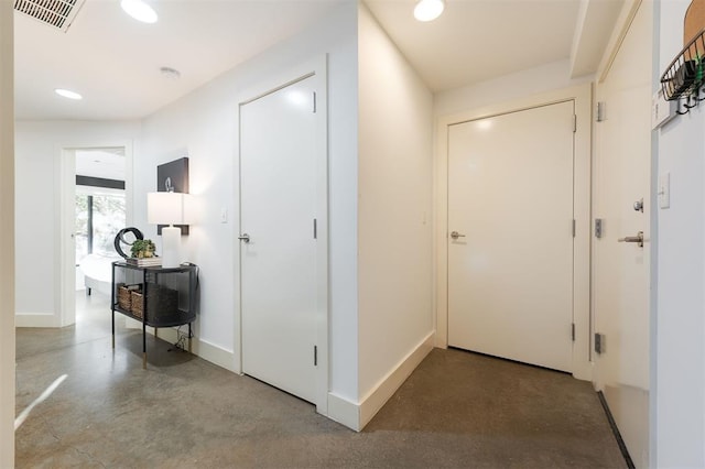 hallway with concrete floors