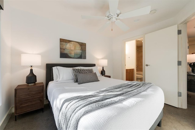 carpeted bedroom with ensuite bath and ceiling fan