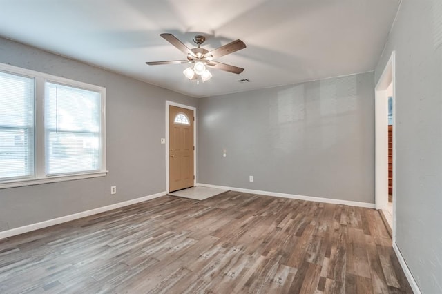 empty room with hardwood / wood-style flooring and ceiling fan