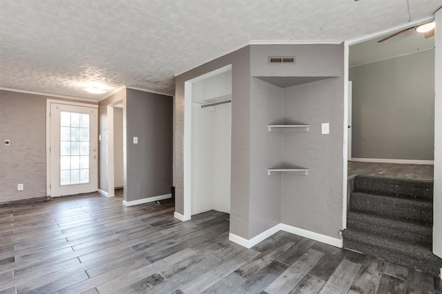 interior space featuring hardwood / wood-style floors, ceiling fan, and ornamental molding