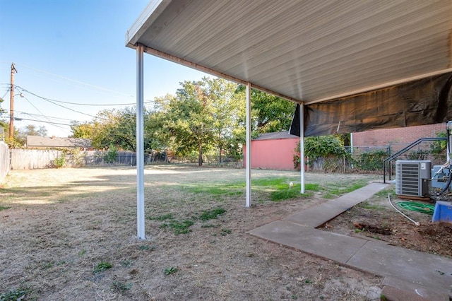 view of yard featuring a shed and central AC unit