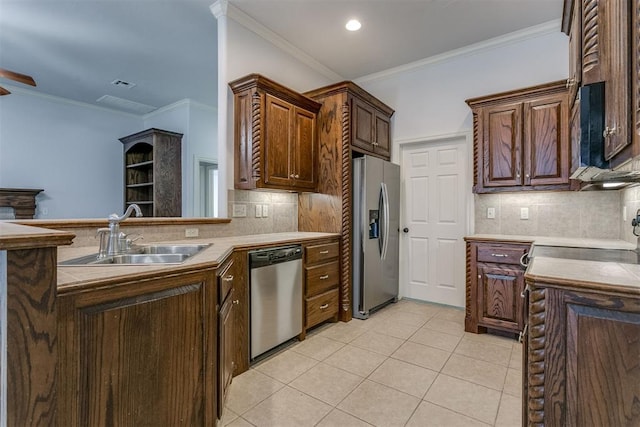 kitchen with decorative backsplash, sink, ornamental molding, and appliances with stainless steel finishes