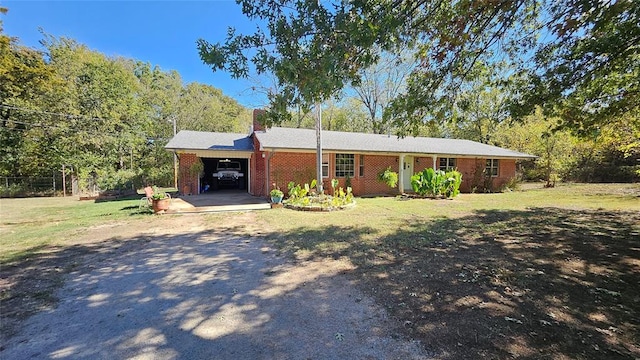 ranch-style house featuring a front yard and a carport