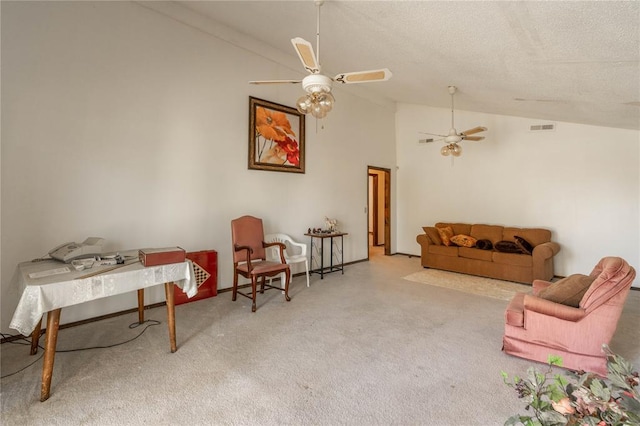 living area with high vaulted ceiling, light colored carpet, and a textured ceiling