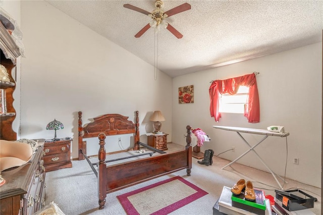 carpeted bedroom with vaulted ceiling, ceiling fan, and a textured ceiling