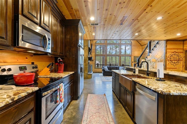 kitchen featuring wooden walls, stainless steel appliances, and wooden ceiling