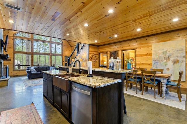 kitchen featuring dishwasher, light stone countertops, a kitchen island with sink, and wooden ceiling