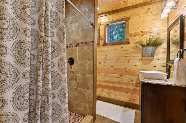 bathroom with a shower with curtain, vanity, wood walls, and wooden ceiling