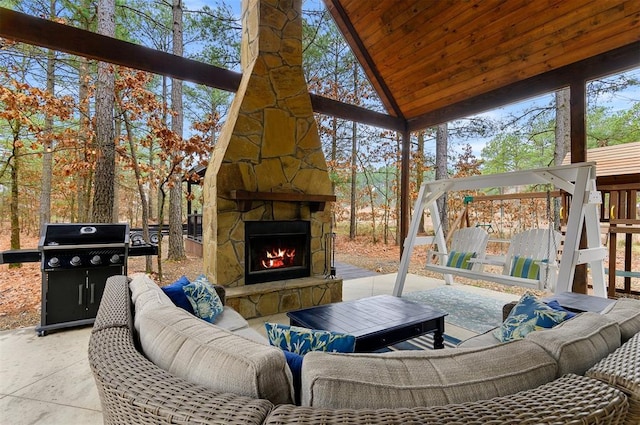 view of patio with an outdoor living space with a fireplace and area for grilling