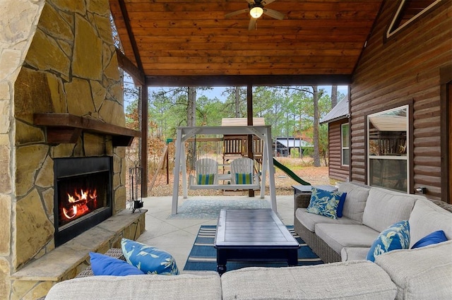 view of patio / terrace featuring an outdoor living space with a fireplace and ceiling fan