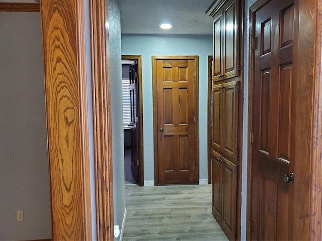 hall with light hardwood / wood-style flooring