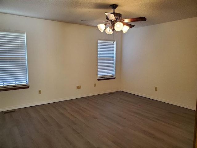 spare room with a textured ceiling, dark hardwood / wood-style floors, and ceiling fan