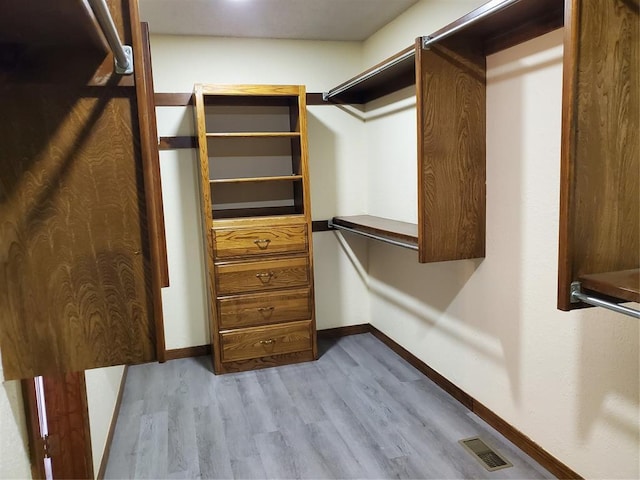 walk in closet featuring light hardwood / wood-style flooring