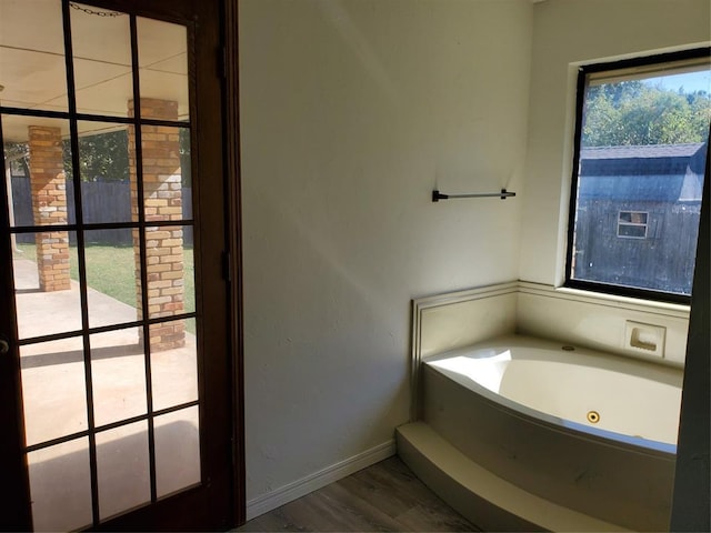 bathroom with a bathtub and wood-type flooring